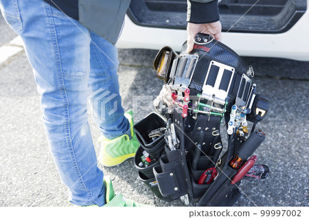 Young female worker preparing waist gear on site Young female worker preparing waist gear on site 99997002