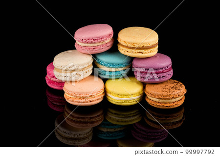 Colorful macaroon over black background Colorful macaroon over black background 99997792