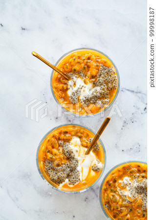 Chia pudding with passion fruit and coconut yogurt in glass. Healthy vegan recipe. Chia pudding with passion fruit and coconut yogurt in glass. Healthy vegan recipe. 99998187