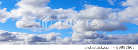 Widescreen panorama of blue sky with white clouds Widescreen panorama of blue sky with white clouds 99998605
