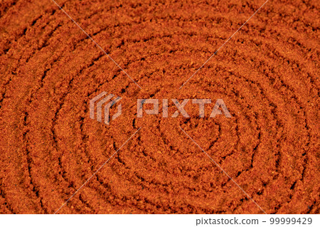 Spiral poured paprika spice powder background. Dry seasoning Paprika. Spices and herbs for cooking, bell pepper Spiral poured paprika spice powder background. Dry seasoning Paprika. Spices and herbs for cooking, bell pepper 99999429
