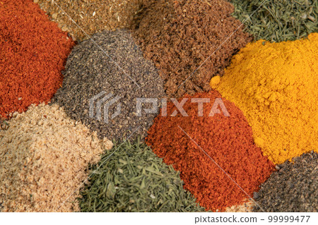 Various fragrant spice market. Spice and seasoning. Heap different Asian Spices lies on wooden background. Assortment spices and herbs for cooking 99999477