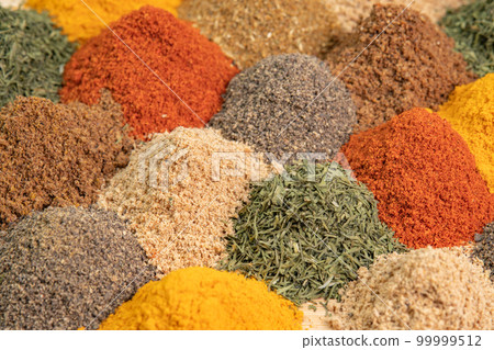 Various fragrant spice market. Spice and seasoning. Heap different Asian Spices lies on wooden background. Assortment spices and herbs for cooking 99999512