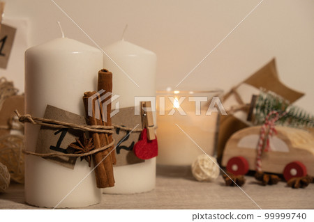 Candle with advent calendar Traditional Burning Christmas Wax Candles with numbers counting down for Christmas. Beautiful Advent At Home. Festive Candlelight And Dark Background 99999740