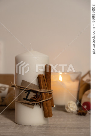 Candle with advent calendar Traditional Burning Christmas Wax Candles with numbers counting down for Christmas. Beautiful Advent At Home. Festive Candlelight And Dark Background Candle with advent calendar Traditional Burning Christmas Wax Candles with numbers counting down for Christmas. Beautiful Advent At Home. Festive Candlelight And Dark Background 99999808
