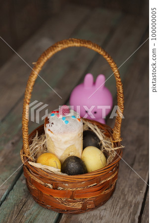Rabbit with Easter eggs on wooden background. Selective focus. 100000005