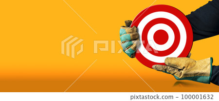Gloved Hands Holding a Red and White Target on an Orange Background Gloved Hands Holding a Red and White Target on an Orange Background 100001632