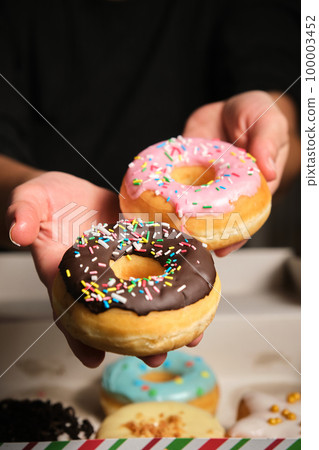 two donuts in a woman's hand 100003452