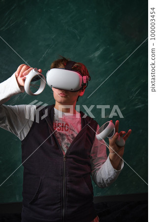 a boy playing with VR glasses a boy playing with VR glasses 100003454