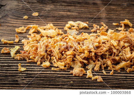 Dried onions on dark rustic wooden background. Dried onions on dark rustic wooden background. 100003868