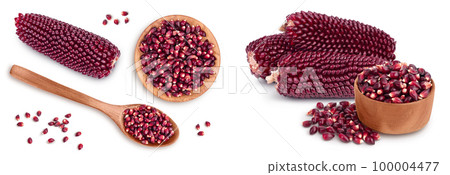 Purple corn or maize seeds in wooden bowl isolated on white background. Top view. Flat lay 100004477