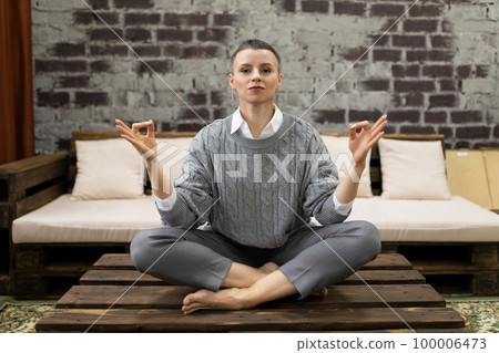 successful female freelancer doing yoga in a cozy atmosphere successful female freelancer doing yoga in a cozy atmosphere 100006473