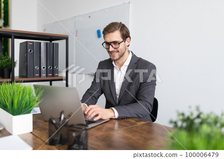 financial worker working on business task while sitting with laptop financial worker working on business task while sitting with laptop 100006479