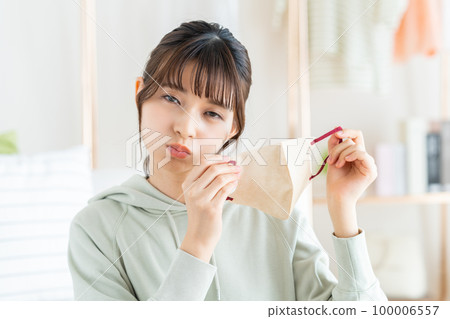 Young woman removing the mask 100006557