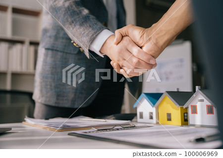 Close up shake hands, Considering buying a home, investing in real estate. Broker signs a sales agreement. agent, lease agreement, successful deal. Close up shake hands, Considering buying a home, investing in real estate. Broker signs a sales agreement. agent, lease agreement, successful deal. 100006969