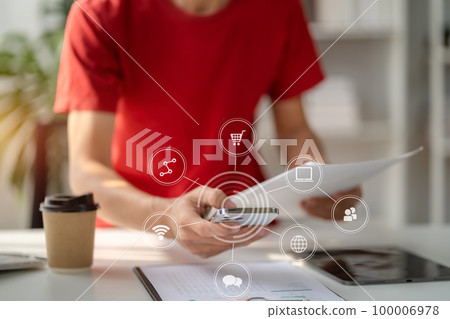 Businessman using mobile phone play social in office. 100006978