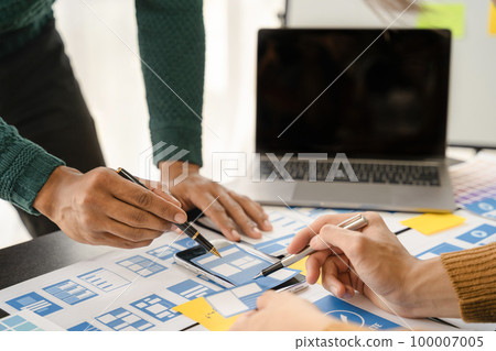 Creative digital development agency. developer team brainstorming on their project with laptop, smartphone and digital tablet. Creative digital development agency. developer team brainstorming on their project with laptop, smartphone and digital tablet. 100007005