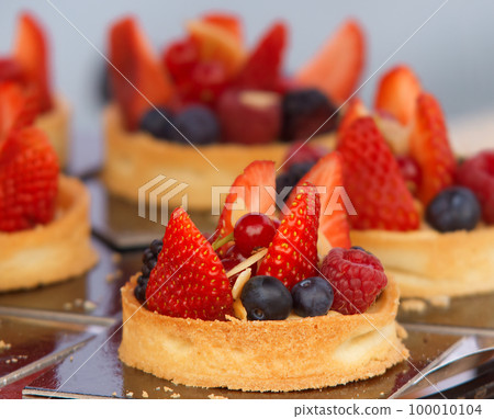 Mini cakes, fruit tarts ans other pastries displayed at the farmers street market in Prague Mini cakes, fruit tarts ans other pastries displayed at the farmers street market in Prague 100010104
