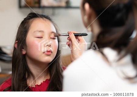 girl getting makeup done by mom girl getting makeup done by mom 100011078