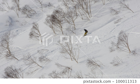 A snowboarder skiing a stream in the backcountry mine area of Niseko Annupuri in Kutchan-cho, Abuta-gun, Hokkaido A snowboarder skiing a stream in the backcountry mine area of Niseko Annupuri in Kutchan-cho, Abuta-gun, Hokkaido 100011313