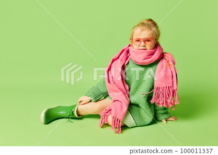 Happy smiling cute kid, little girl in fashionable look clothes and sunglasses posing over light green background. Spring fashion collection, happiness, ad concept Happy smiling cute kid, little girl in fashionable look clothes and sunglasses posing over light green background. Spring fashion collection, happiness, ad concept 100011337