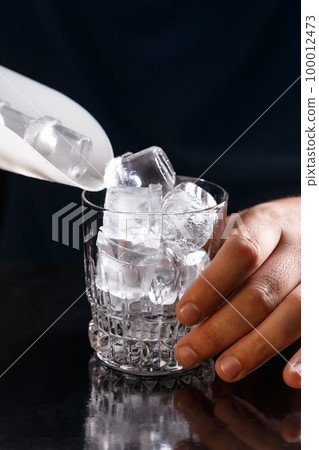 Ice cube in glass 100012473