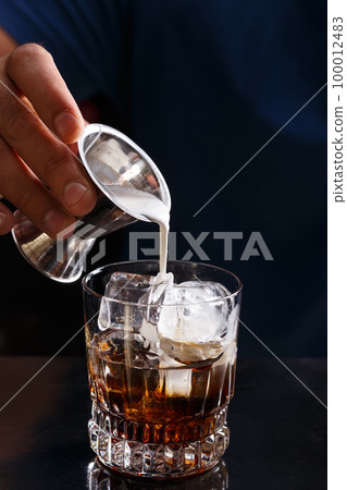 Bartender prepares a white russian cocktail Bartender prepares a white russian cocktail 100012483