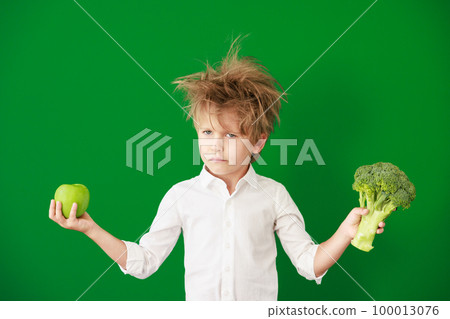 Surprised child against green chalkboard in class Surprised child against green chalkboard in class 100013076