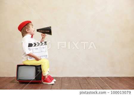 Newsboy shouting against grunge wall background. Boy selling newspaper Newsboy shouting against grunge wall background. Boy selling newspaper 100013079