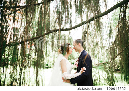 Gorgeous happy couple standing close to each other and looking in eyes 100013232