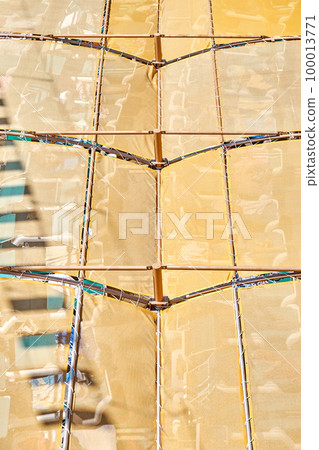 Orange canopy over sun loungers in recreation area of water park. Tourist equipment as background. Protective cover at summer resort closeup Orange canopy over sun loungers in recreation area of water park. Tourist equipment as background. Protective cover at summer resort closeup 100013771