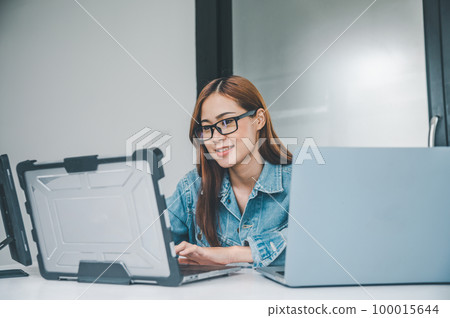 Female programmer working on coding, software development and web design.Concept technology development. Female programmer working on coding, software development and web design.Concept technology development. 100015644