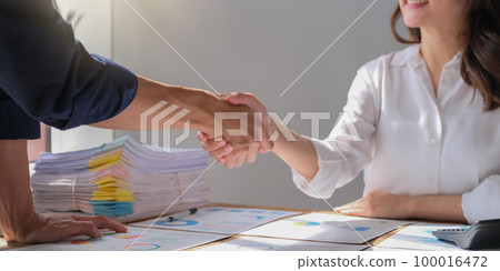 The business people shake hands after the meeting was successful and agreed upon The business people shake hands after the meeting was successful and agreed upon 100016472