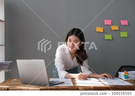 Closeup businessperson analyzing graph and chart document report Closeup businessperson analyzing graph and chart document report 100016505