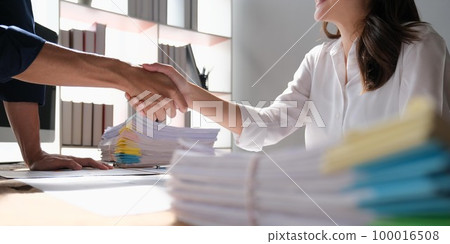 The business people shake hands after the meeting was successful and agreed upon The business people shake hands after the meeting was successful and agreed upon 100016508