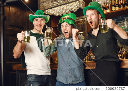 Men celebrate St. Patrick's Day at bar with a mug of beer Men celebrate St. Patrick's Day at bar with a mug of beer 100020787