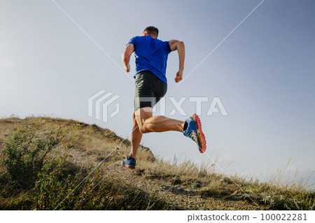 back athlete runner run mountain trail on background sky back athlete runner run mountain trail on background sky 100022281