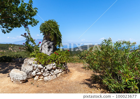 Summer landscape with flowers an old in round stone well. Zakynthos Summer landscape with flowers an old in round stone well. Zakynthos 100023677