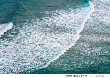 Aerial view of surfers surfing waves in Beach of Antuerta in Ajo 100023800
