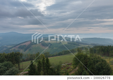 View from lookout tower Velky Javornik to Beskid Mountains in summer cloudy evening 100026778