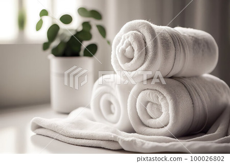 a roll of towels on a table in a bright room. concept of cleanliness, spa a roll of towels on a table in a bright room. concept of cleanliness, spa 100026802