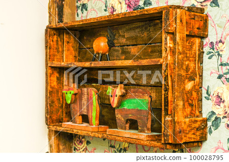 A simple old used wooden box on the wall of the room as a shelf in a vintage style interior A simple old used wooden box on the wall of the room as a shelf in a vintage style interior 100028795