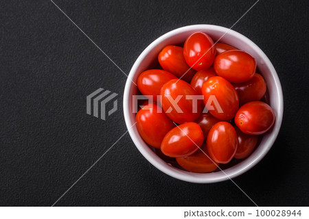 Fresh tasty cherry tomatoes in a white ribbed bowl Fresh tasty cherry tomatoes in a white ribbed bowl 100028944