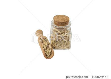 siberian ginseng in latin Eleutherococcus senticosus in wooden scoop and glass jar on isolated on white 100029448