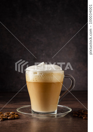 Cups of coffee drink, latte or mocha with milk foam. Glass mug, dark wooden background 100034001