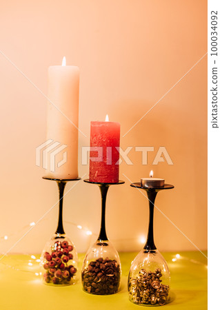 Composition of glasses, candles and decorative elements. New Year's mood Composition of glasses, candles and decorative elements. New Year's mood 100034092