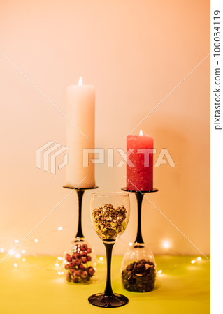 Composition of glasses, candles and decorative elements. New Year's mood 100034119