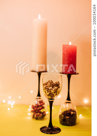 Composition of glasses, candles and decorative elements. New Year's mood Composition of glasses, candles and decorative elements. New Year's mood 100034164