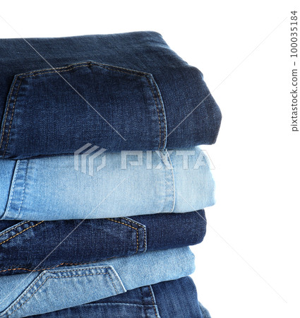 Stack of different jeans isolated on white Stack of different jeans isolated on white 100035184