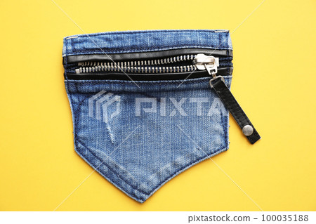 Stylish jeans pocket with zipper on yellow background, top view Stylish jeans pocket with zipper on yellow background, top view 100035188